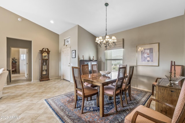 tiled dining space with an inviting chandelier and lofted ceiling