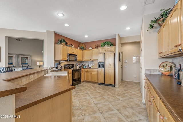 kitchen featuring light brown cabinetry, sink, black appliances, light tile patterned floors, and backsplash