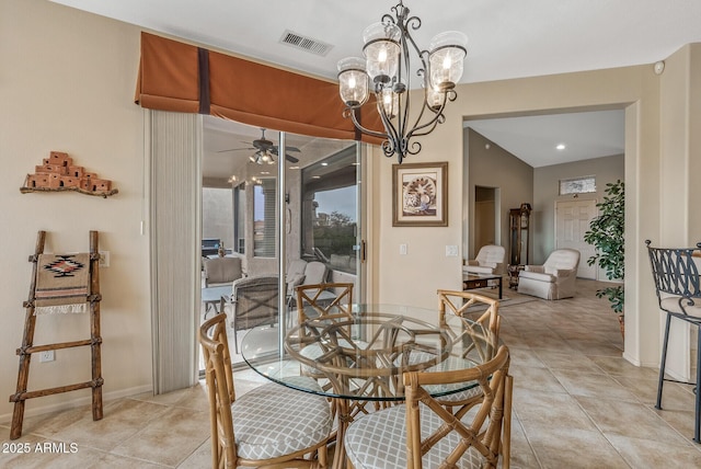 tiled dining room featuring ceiling fan with notable chandelier