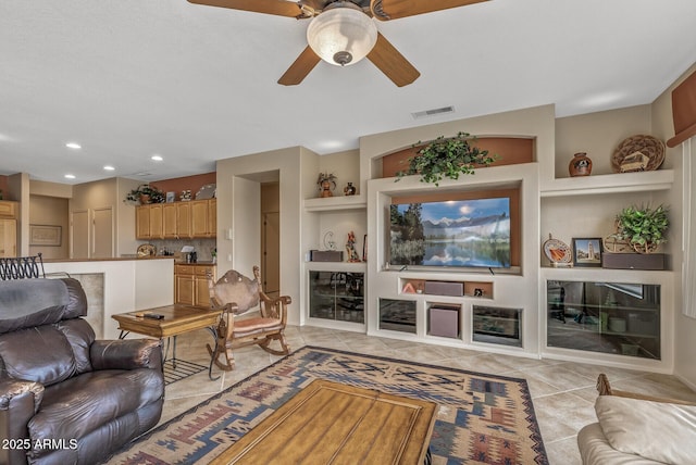 living room featuring light tile patterned flooring, ceiling fan, and built in features