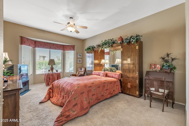 bedroom featuring light colored carpet and ceiling fan