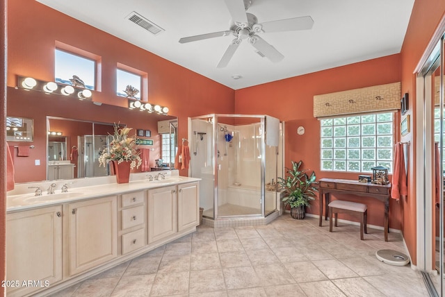 bathroom with vanity, tile patterned flooring, ceiling fan, and walk in shower