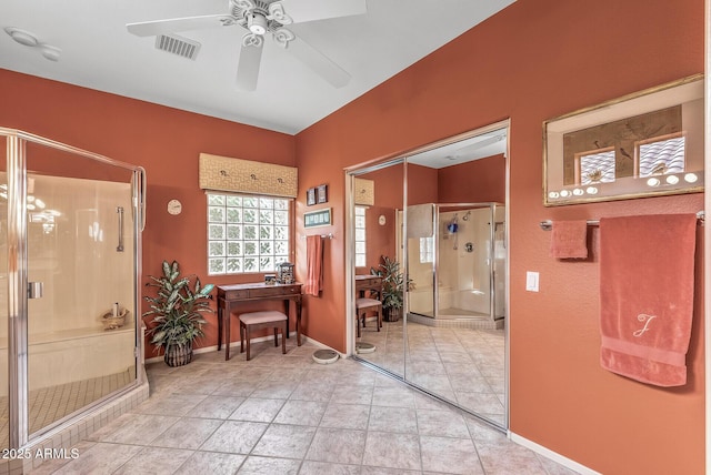 bathroom with ceiling fan and a shower with shower door