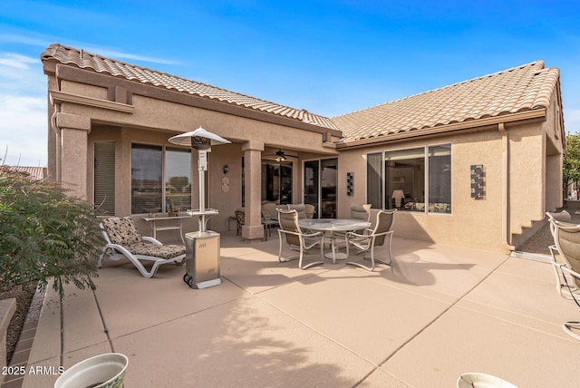 back of house featuring ceiling fan and a patio area