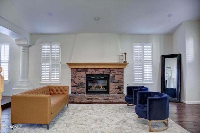 1707 E Carob Dr, Chandler, AZ 85286 - living area with ornate columns, wood finished floors, a fireplace, and baseboards