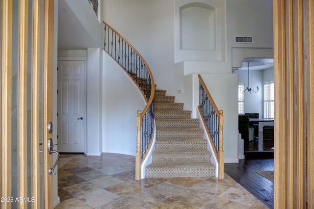 1707 E Carob Dr, Chandler, AZ 85286 - staircase featuring baseboards and a towering ceiling