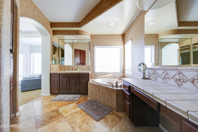1707 E Carob Dr, Chandler, AZ 85286 - full bathroom featuring plenty of natural light, a garden tub, tile patterned floors, and decorative backsplash