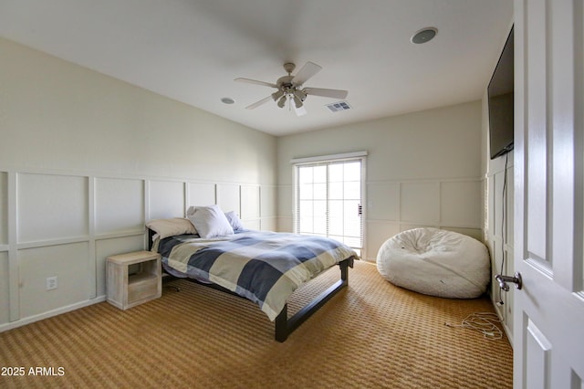 1707 E Carob Dr, Chandler, AZ 85286 - bedroom featuring a decorative wall, carpet floors, a ceiling fan, and a wainscoted wall