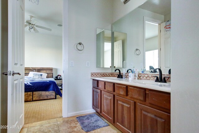 1707 E Carob Dr, Chandler, AZ 85286 - ensuite bathroom featuring a ceiling fan, double vanity, tile patterned flooring, and baseboards