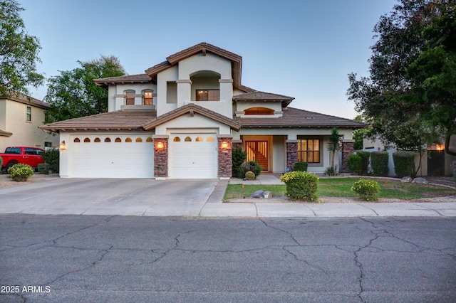 1707 E Carob Dr, Chandler, AZ 85286 - view of front of home featuring stucco siding, driveway, stone siding, and an attached garage