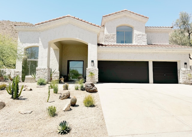 11446 E Sweetwater Ave, Scottsdale, AZ 85259 - mediterranean / spanish-style home featuring concrete driveway, a tiled roof, stucco siding, and a garage