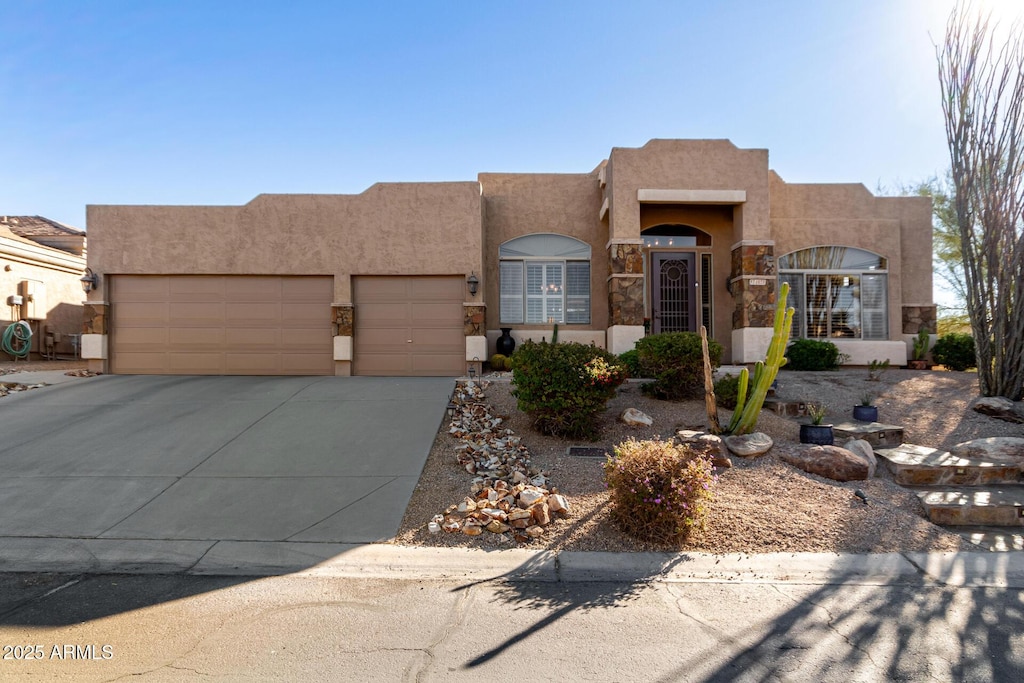 pueblo-style home featuring a garage