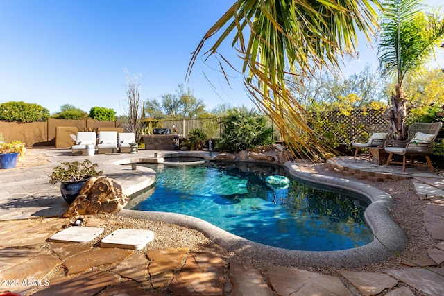 view of pool featuring a patio area and an in ground hot tub