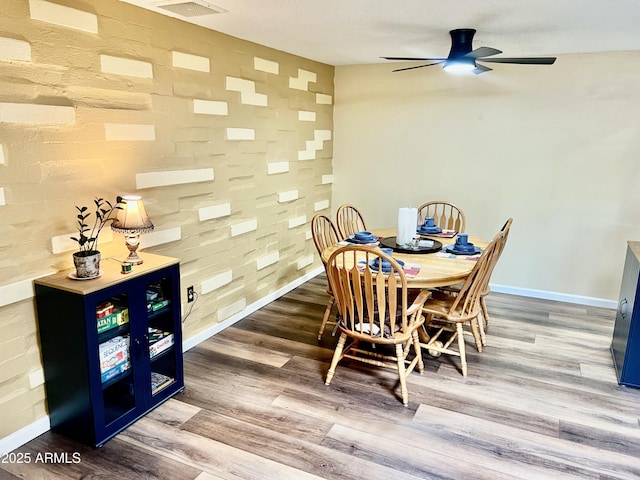 dining area featuring ceiling fan and hardwood / wood-style flooring