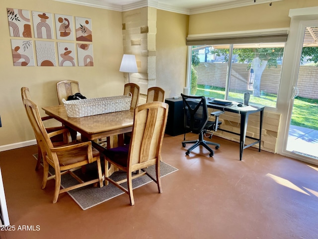 dining area featuring concrete floors and crown molding