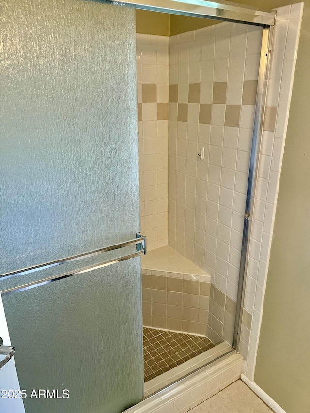 bathroom with a shower with door