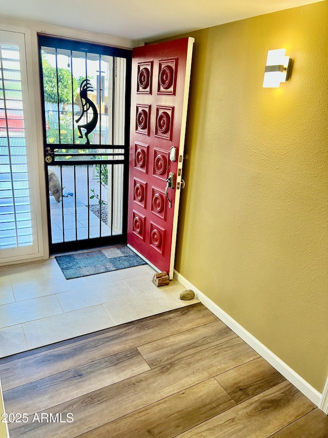 entryway with hardwood / wood-style floors