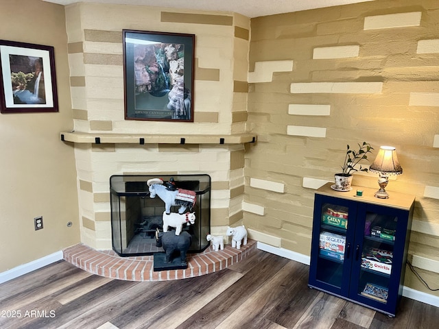 room details with a brick fireplace and hardwood / wood-style flooring