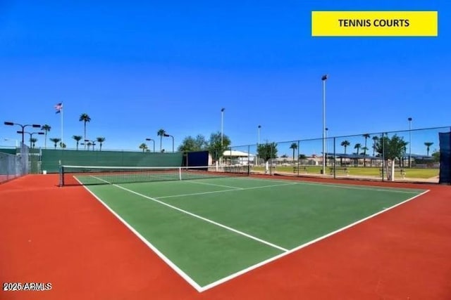 view of tennis court featuring basketball hoop