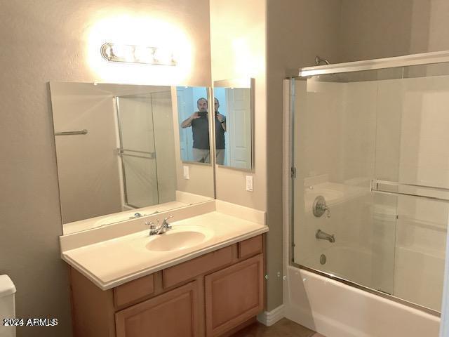 bathroom featuring vanity and bath / shower combo with glass door