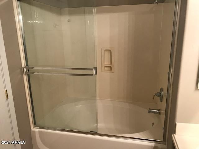 bathroom featuring vanity and bath / shower combo with glass door