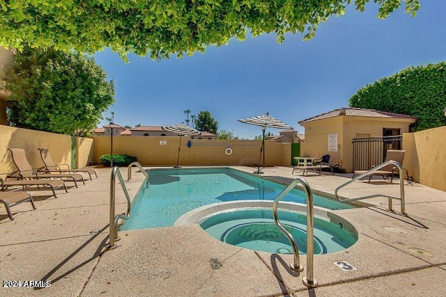 view of swimming pool with a community hot tub and a patio