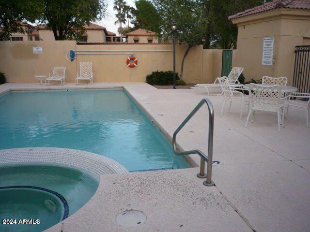 view of pool featuring a patio area and a hot tub