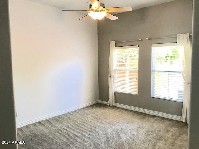 carpeted empty room with ceiling fan