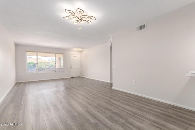 9603 W Calico Dr, Sun City, AZ 85373 - empty room with wood finished floors and baseboards