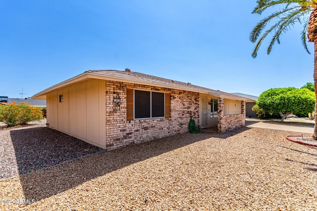 9603 W Calico Dr, Sun City, AZ 85373 - ranch-style home with a garage, brick siding, and roof with shingles