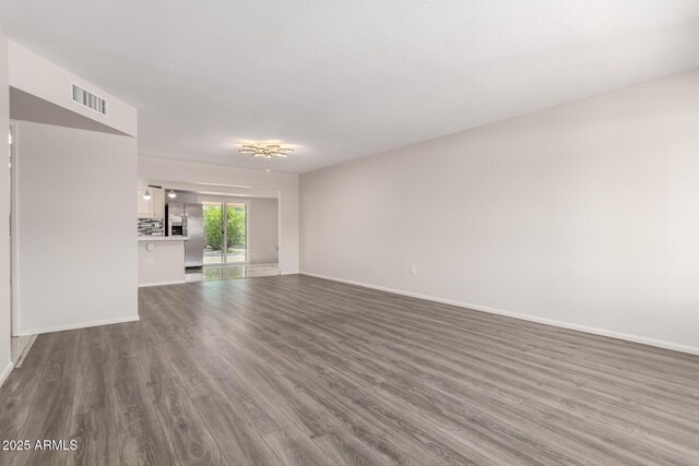9603 W Calico Dr, Sun City, AZ 85373 - unfurnished living room featuring wood finished floors