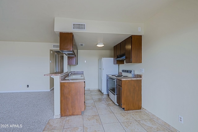 kitchen with light countertops, visible vents, electric range oven, a sink, and under cabinet range hood