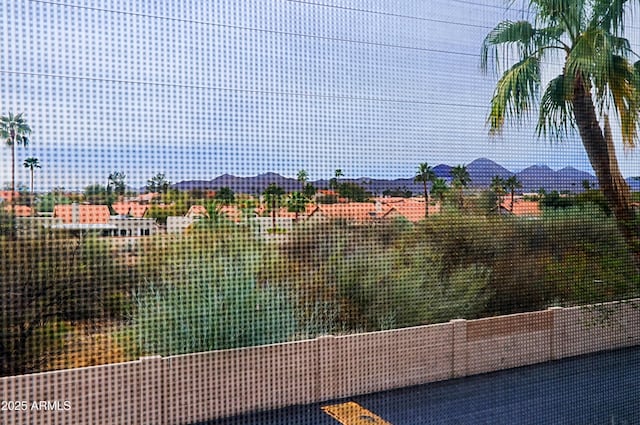 view of tennis court featuring a mountain view