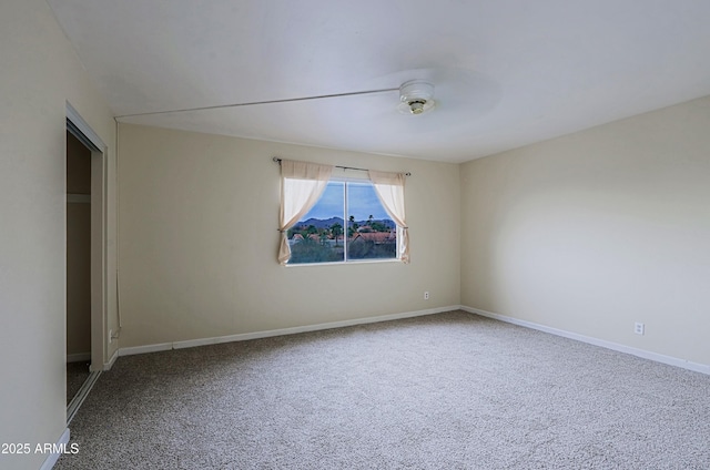 carpeted empty room with baseboards