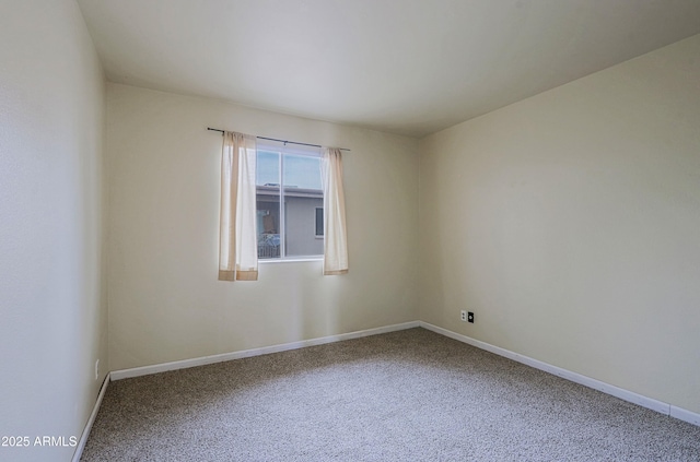 spare room with carpet flooring and baseboards