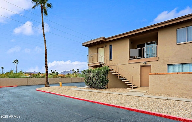 view of front of home featuring stairs and stucco siding