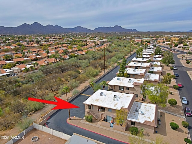 drone / aerial view featuring a residential view and a mountain view