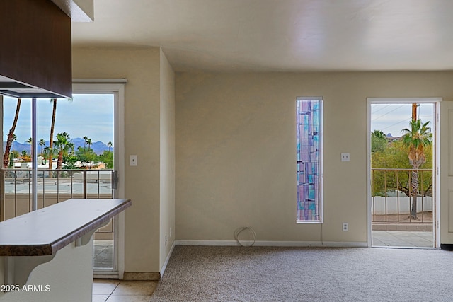 interior space featuring light carpet and baseboards