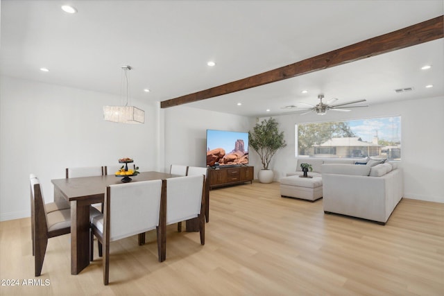 dining space with light hardwood / wood-style flooring, beamed ceiling, and ceiling fan