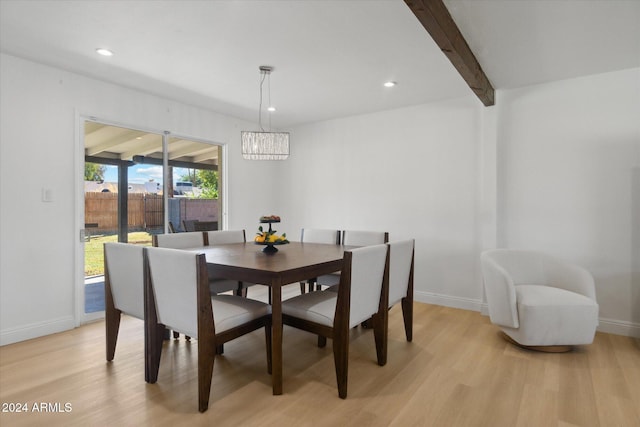 dining area with beamed ceiling and light hardwood / wood-style floors