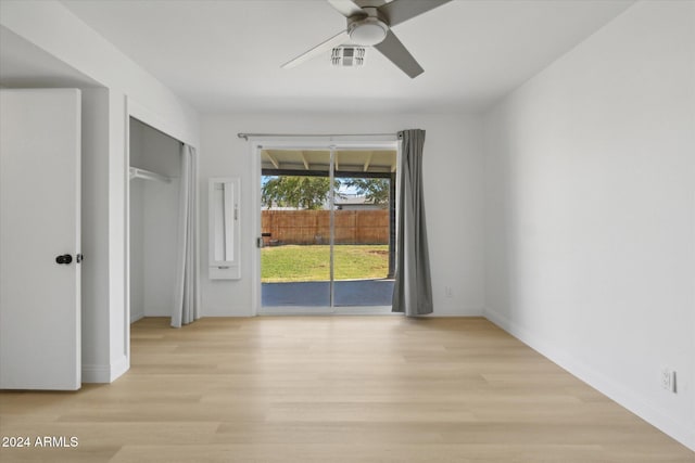 spare room featuring light hardwood / wood-style floors and ceiling fan