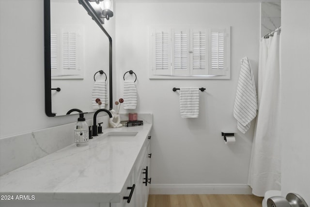 bathroom with vanity, curtained shower, and wood-type flooring