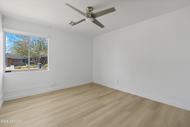 spare room with ceiling fan and light wood-type flooring