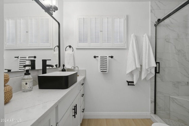 bathroom with vanity, walk in shower, and hardwood / wood-style floors