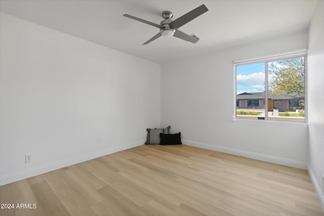 empty room with light wood-type flooring and ceiling fan