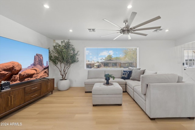 living room featuring ceiling fan and light hardwood / wood-style flooring