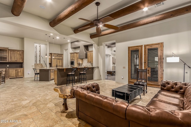 living area with ceiling fan, visible vents, beam ceiling, stone tile flooring, and recessed lighting
