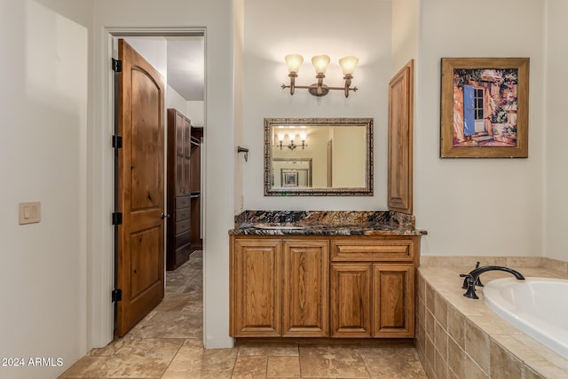 full bathroom with vanity and a bath