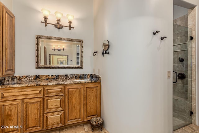 full bath featuring a tile shower and vanity