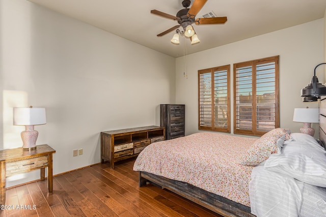 bedroom featuring visible vents, a ceiling fan, and wood finished floors